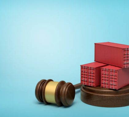 3d rendering of red cargo containers on round wooden block and brown wooden gavel on blue background. Digital art. Objects and materials. Storage and warehousing.